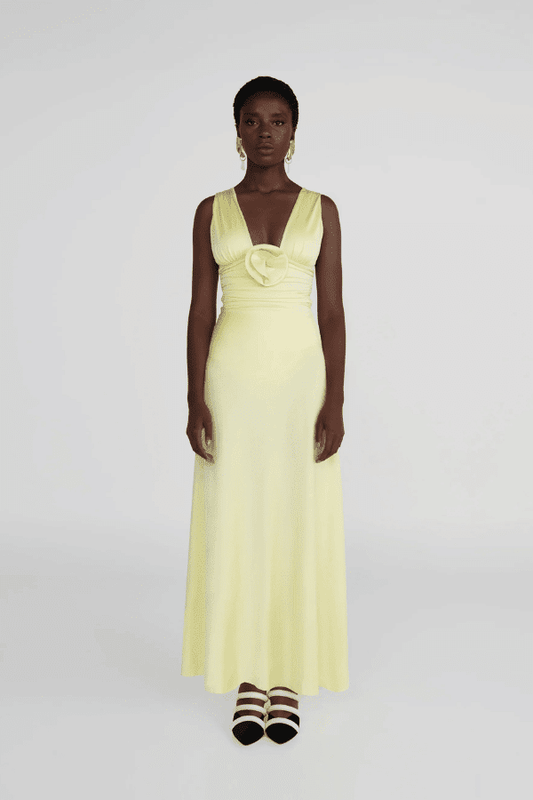 Orinoco Lime by Maygel Coronel – Maxi dress with deep V-neck, ruched bodice, 3D flowers, wide straps, and flowing skirt.