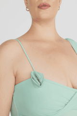 Hilván Mini Dress Salvia by Maygel Coronel – A trendy, sculptural mini with asymmetric neckline, 3D floral strap, ruched bodice, and flowing back sash. Perfect for modern, elegant nights out.