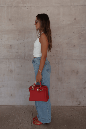 Bella Halter Tank White by Sneaky Link – Soft cotton-spandex blend with a deep scoop neckline, open back, and supportive halter design. Perfect for layering or solo wear.