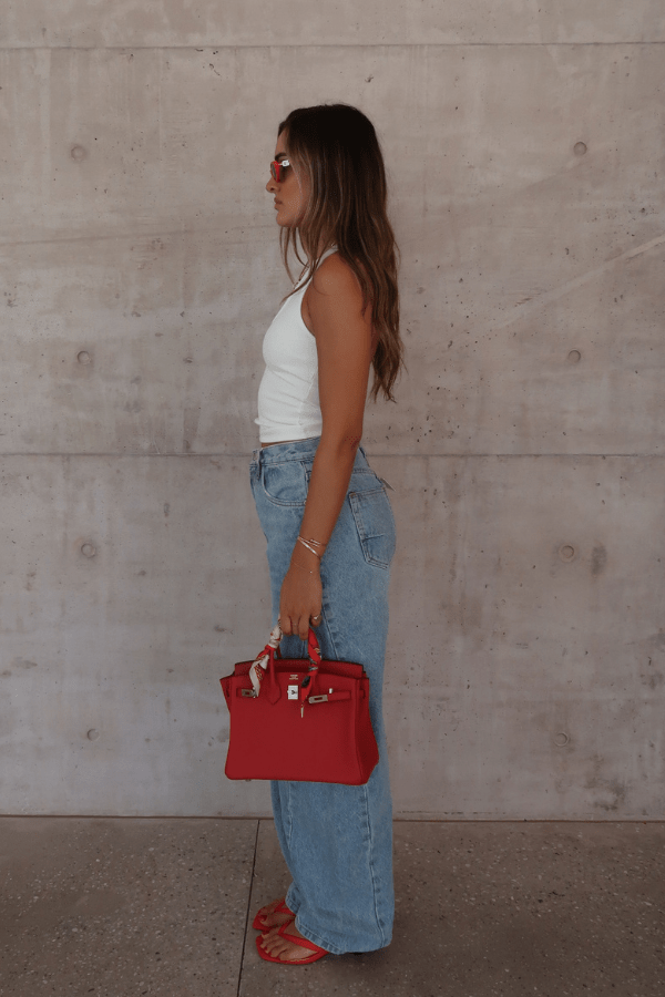 Bella Halter Tank White by Sneaky Link – Soft cotton-spandex blend with a deep scoop neckline, open back, and supportive halter design. Perfect for layering or solo wear.