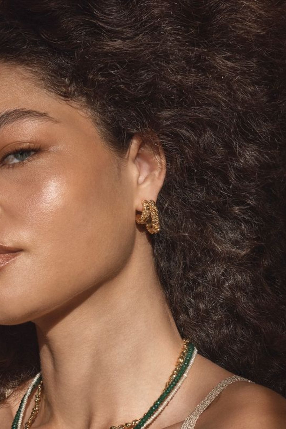 Lucca Earrings by Amber Sceats – handcrafted in Italy with 24K gold-plated brass, featuring a curved silhouette for timeless elegance.
