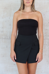 Sneaky Mini Skirt Black by Sneaky Link – A-line high-waisted mini with boned waist and flap pockets, perfect for day-to-night styling.