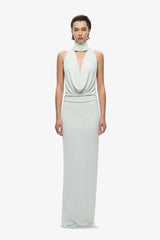 The Cowl Neck Jersey Dress by MISHA, halter cowl maxi with open back and side split for sleek evening styling.