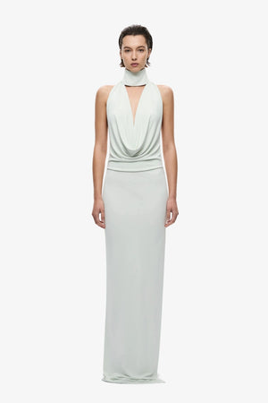 The Cowl Neck Jersey Dress by MISHA, halter cowl maxi with open back and side split for sleek evening styling.