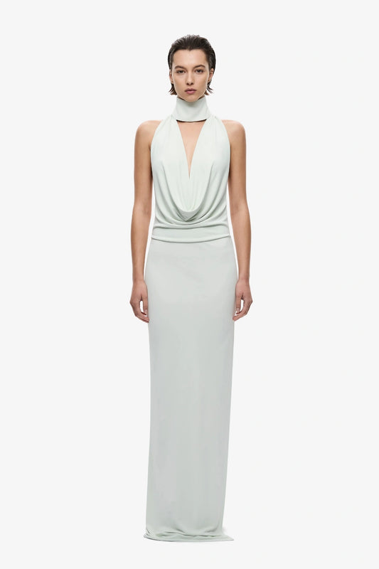 The Cowl Neck Jersey Dress by MISHA, halter cowl maxi with open back and side split for sleek evening styling.