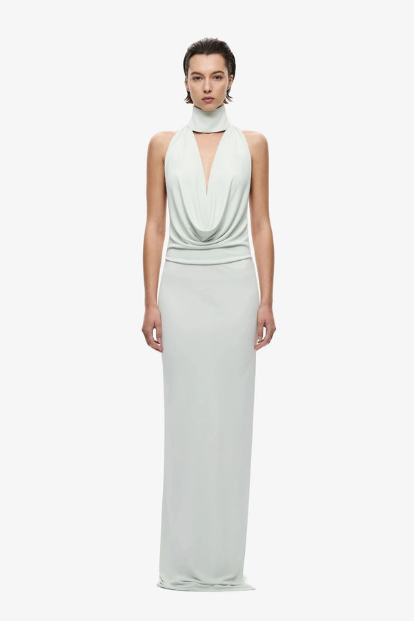 The Cowl Neck Jersey Dress by MISHA, halter cowl maxi with open back and side split for sleek evening styling.