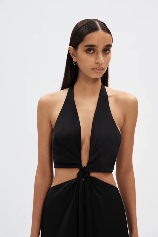 The Wander Satin Gown Black by Misha – A timeless, elegant maxi gown in lightweight satin with a flattering twisted front detail, perfect for warm evening events.