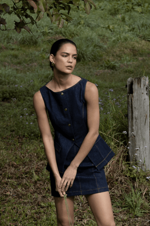 Good Vibes Top Indigo by Pasduchas – Trendy stretch denim with structured fit, gold snap studs, and mock pockets; perfect for chic, coordinated looks.