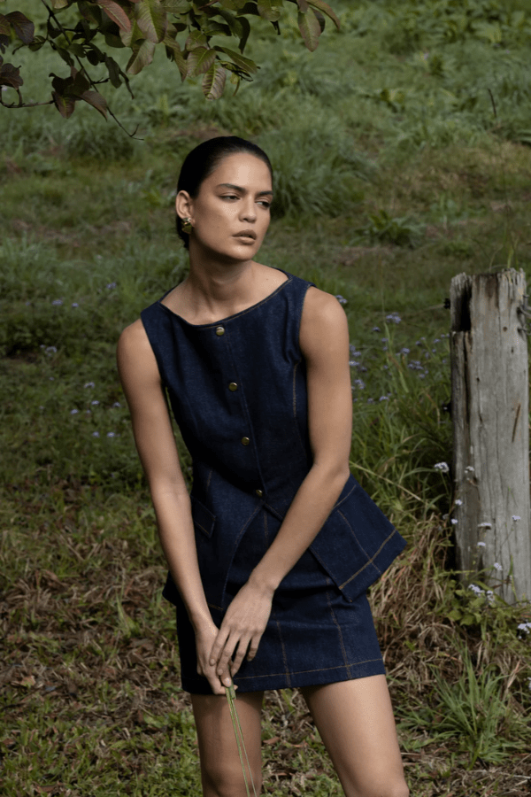 Good Vibes Top Indigo by Pasduchas – Trendy stretch denim with structured fit, gold snap studs, and mock pockets; perfect for chic, coordinated looks.