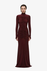 The Gathered Long Sleeve Maxi Dress by MISHA, ruched jersey maxi with mock neck and flared hem for sculpted evening styling.