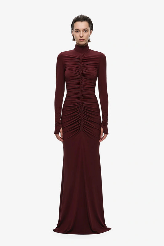 The Gathered Long Sleeve Maxi Dress by MISHA, ruched jersey maxi with mock neck and flared hem for sculpted evening styling.