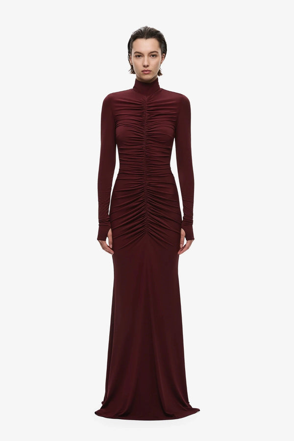 The Gathered Long Sleeve Maxi Dress by MISHA, ruched jersey maxi with mock neck and flared hem for sculpted evening styling.