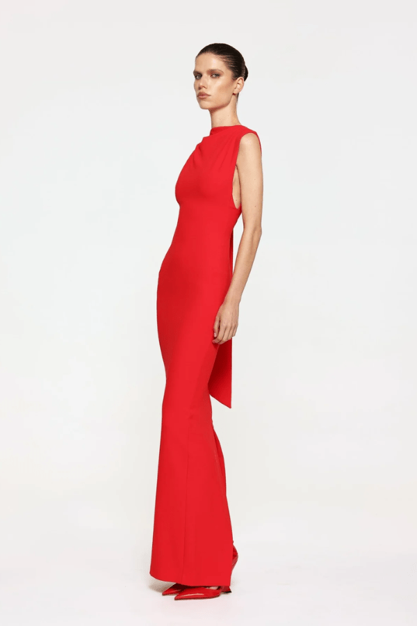 Audrey Gown Cherry Red by Effie Kats – A chic stretch crepe gown with a straight neckline, exaggerated low back, and elegant over-the-shoulder detail, perfect for special occasions.