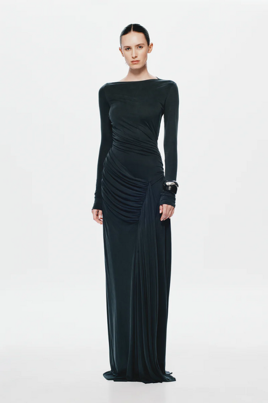 The 'Glacier' Long Sleeve Dress Black by MISHA, full-length black maxi with sculptural draping, high boat neckline, asymmetrical pleats, dry clean only.