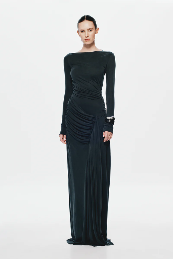 The 'Glacier' Long Sleeve Dress Black by MISHA, full-length black maxi with sculptural draping, high boat neckline, asymmetrical pleats, dry clean only.