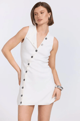 Astrid Knit Dress Almond by Sovere – A trendy vest-style mini with asymmetric neckline and button closure, blending structure with modern sophistication for versatile wear.