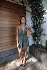 Lefkothea Mini Dress Khaki by D'Artemide – One-size cotton mini with halter tie, deep V neckline, low back, and side cutouts.
