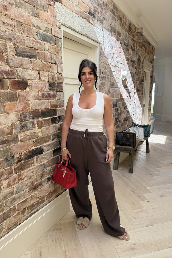 Chocolate Knitted Baggy Pants by Something Very Special, featuring stripe jacquard and tonal embroidery. Unisex comfort redefined.