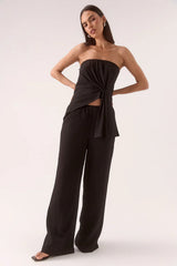 Aine Top Black by Sovere – a strapless crinkle top with pleated waist and asymmetric hem. Perfect for summer styling.