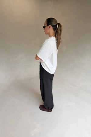 White Olivia High V Neck Relaxed Tee with short sleeves and a loose fit on a plain background.