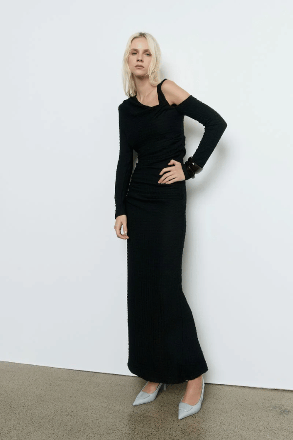 Solstice Dress Black by Sovere – Trendy fitted midi with asymmetric neckline, off-shoulder sleeve, and pleat details, perfect for elegant evening occasions and standout style.