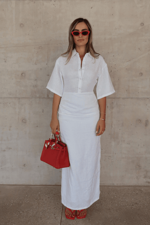 Lefka Midi Dress White by Sneaky Link – Breezy 100% linen midi with button-front and flattering tucks. Perfect for trendy summer strolls or viral lunch dates.