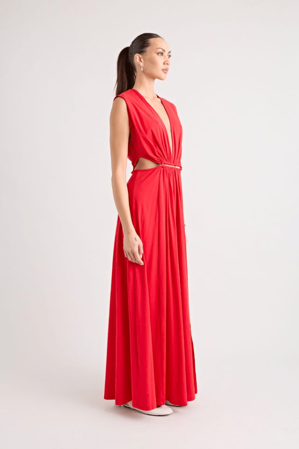 Do For Love Gown Red by Pfeiffer – A trendy low plunge maxi gown with bold hardware and thigh-high split, perfect for turning heads at special occasions.