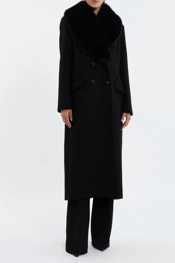 Biera Coat Black by Rebecca Vallance – A boxy, double-breasted wool coat with flap pockets, embossed dome buttons, and removable faux fur trim. Fully lined for comfort.