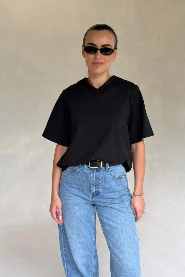 Black Olivia High V Neck Relaxed Tee with short sleeves and a loose fit on a plain background.
