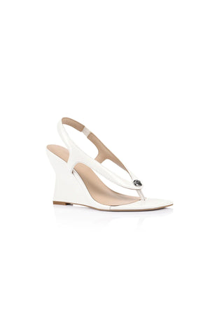 Martine Wedge by Lana Wilkinson — a white leather T-bar wedge with a sculpted 9.5cm heel, perfect for clean and elegant summer styling.