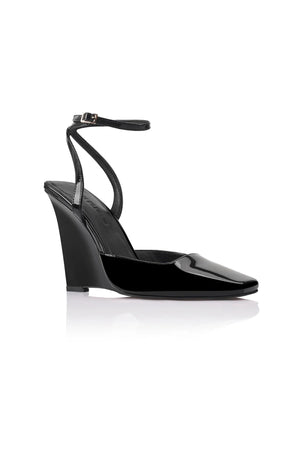 Lana Wilkinson Mona Wedge in black patent leather with pointed toe, high-cut vamp, ankle strap, and sculptural wedge heel.