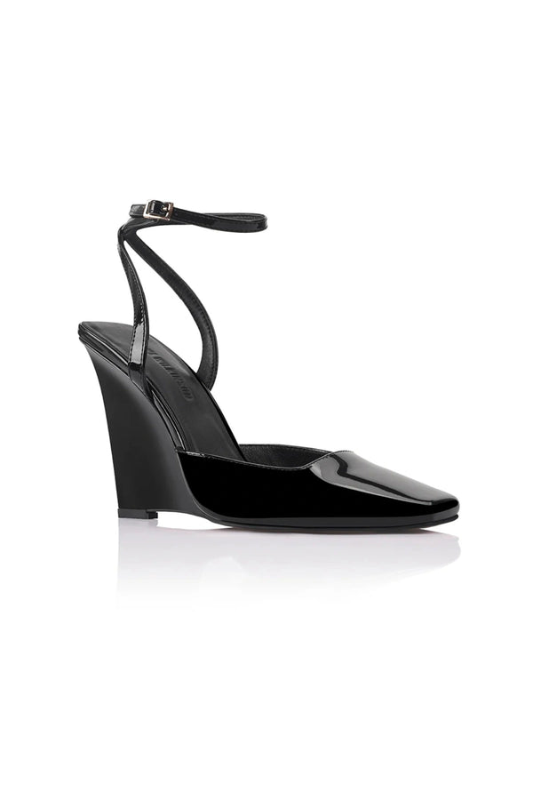 Lana Wilkinson Mona Wedge in black patent leather with pointed toe, high-cut vamp, ankle strap, and sculptural wedge heel.