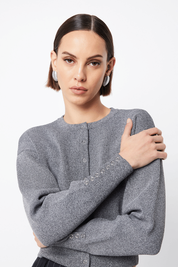 Manhattan Cardigan Pale Grey by Mossman – Relaxed fit crepe knit with round neck, press stud front, ribbed cuffs, and waistband. Soft with stretch. Model wears AU 6.