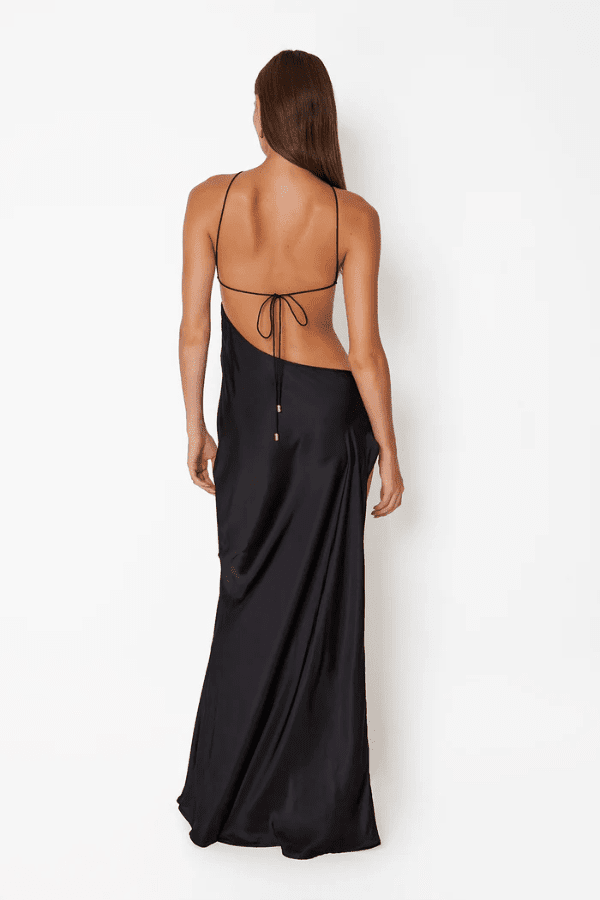 Villa Butterfly Maxi Dress Black by Cin Cin – A bold, trendy maxi dress with asymmetric backless cut-outs, custom flower hardware, and a thigh-high slit for standout glamour. Perfect for special events and evening occasions.