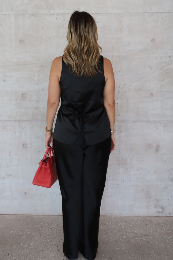 Maja Vest Noir by Sneaky Link, luxurious noir satin vest with drawstring tie and front buttons, perfect for trendy viral layering and polished day-to-night looks.