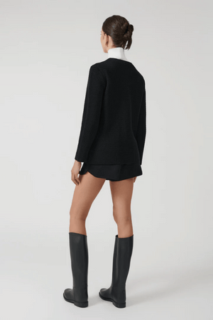 Helena Jacket Black by Onte – A stylish reinterpretation of the iconic Helena gilet, made from breathable 100% cotton yarn with a unique crochet-style stitch. Features a loose fit, gold Onte buttons, long sleeves, crew neck, and patch pockets.