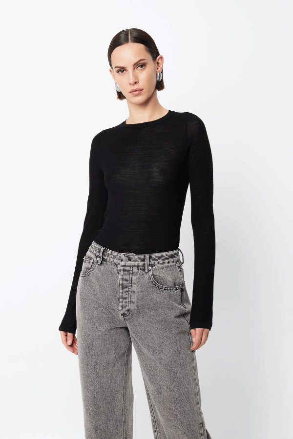 Maine Long Sleeve Top Black by Mossman – A viral, lightweight Merino wool essential with a sleek round neck and body-skimming fit, perfect for year-round layering or solo wear.