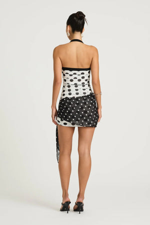 Marnie Mini Dress by Benni, black and white polka halter mini with straight neckline, ruched bodice and scarf wrap tie detail.