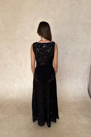 Lucy Lace Maxi Dress in Black by Sneaky Link, a sheer lace gown with draped neckline and elegant silhouette. Perfect for evening occasions.
