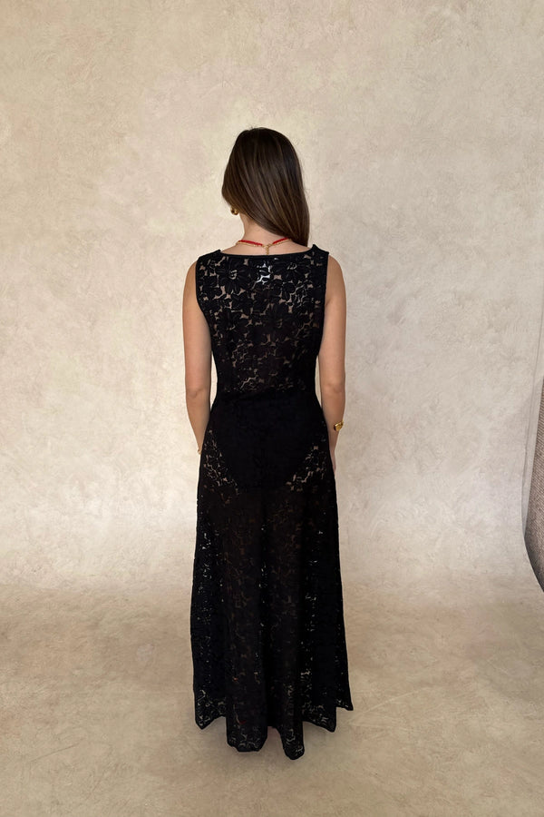Lucy Lace Maxi Dress in Black by Sneaky Link, a sheer lace gown with draped neckline and elegant silhouette. Perfect for evening occasions.

