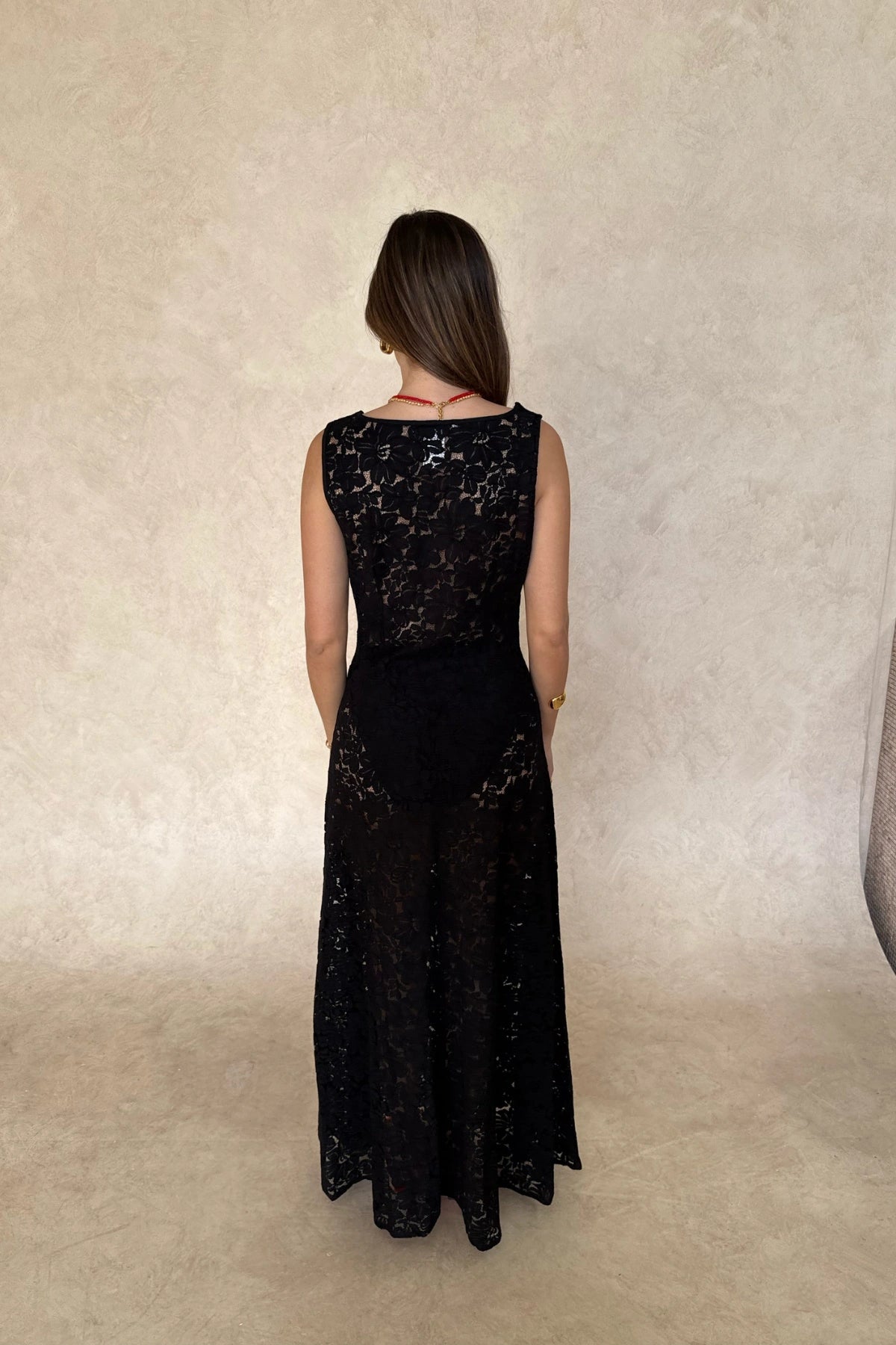 Lucy Lace Maxi Dress in Black by Sneaky Link, a sheer lace gown with draped neckline and elegant silhouette. Perfect for evening occasions.
