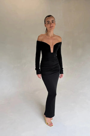 Black Haley off-shoulder midi dress with fitted bodice and flowy skirt, featuring short sleeves and a subtle slit.