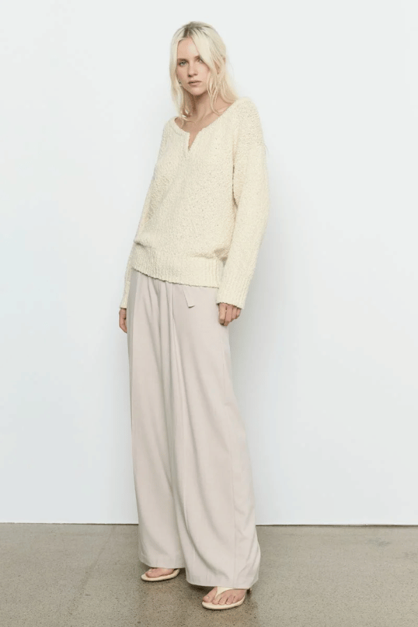 Allure Sweater Soft Yellow by Sovere Studio – Soft, breathable 100% cotton knit with wide 'V' neckline, dropped shoulders, long sleeves, and ribbed finish. Relaxed fit, perfect for layering.
