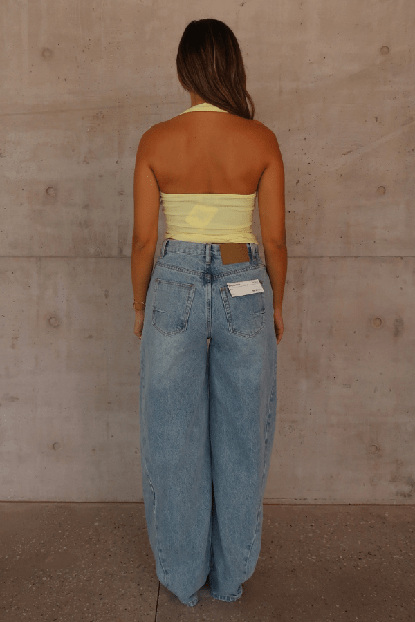 Bella Halter Tank Lemon by Sneaky Link – Soft cotton-spandex tank with deep scoop neckline and open back. A trendy, breathable piece for viral summer vibes.