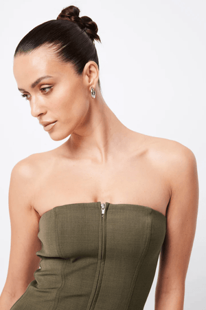 Low Profile Midi Dress Khaki by Mossman – A chic, strapless utility-inspired midi with exposed zip, front pockets, and back split, perfect for modern, versatile styling.