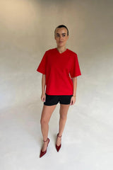 Red Olivia High V Neck Relaxed Tee with short sleeves and a loose fit on a plain background.