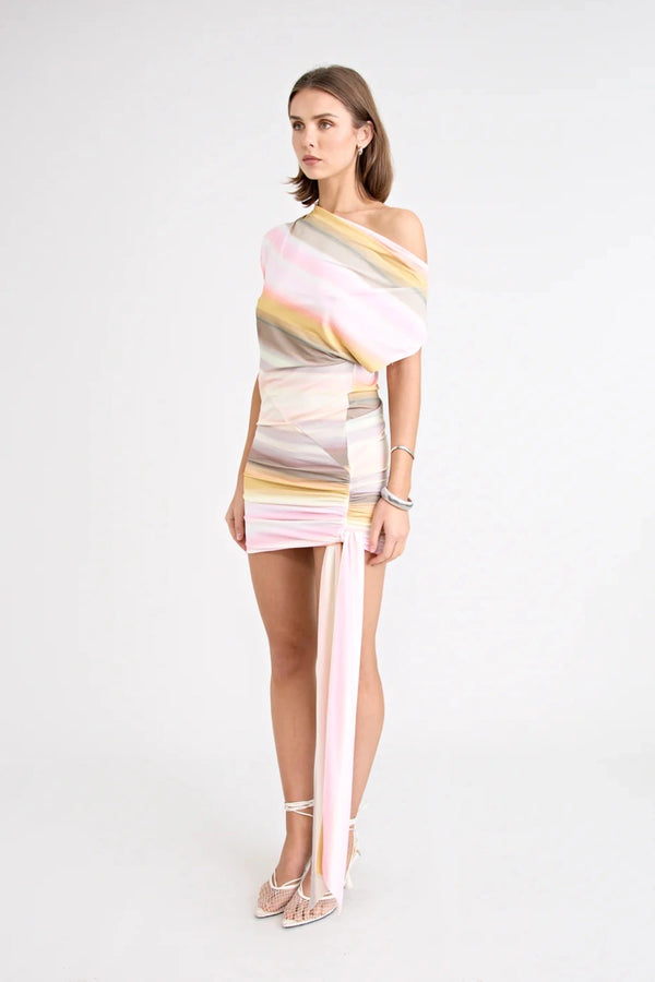Elara Reversible Dress by Pfeiffer — peach printed mini dress with three-way reversible design and dramatic hem tie detail.