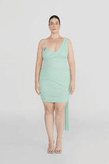 Hilván Mini Dress Salvia by Maygel Coronel – A trendy, sculptural mini with asymmetric neckline, 3D floral strap, ruched bodice, and flowing back sash. Perfect for modern, elegant nights out.