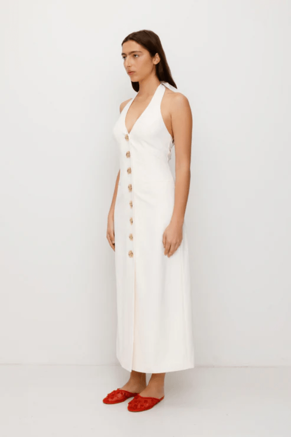 Irida Maxi Dress Ivory by The Wolf Gang – A trendy fitted maxi with halter neckline and gold swirl details, perfect for timeless elegance at special occasions.