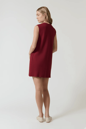 Nanda Dress Burgundy by Onte – Trendy sleeveless shift in heavy Milano knit with gold knot buttons, flattering A-line silhouette, perfect for chic day or night looks.